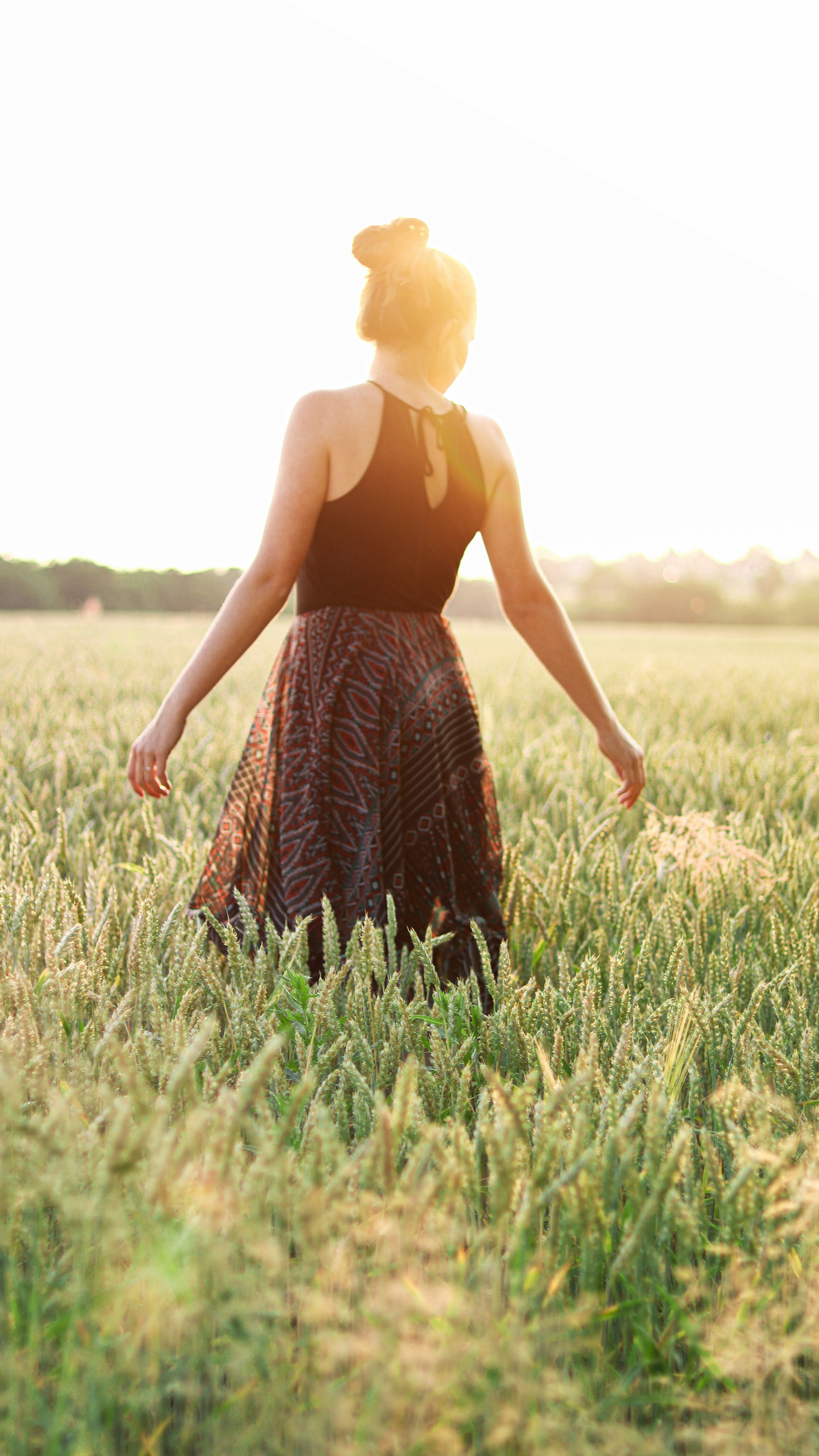 girl in the field from behind