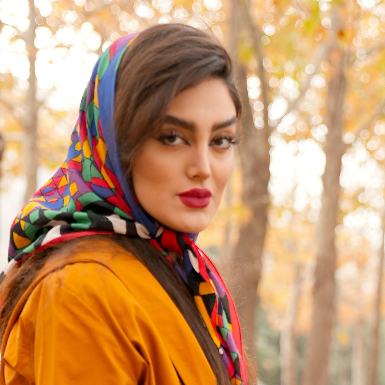 Beautiful girl in autumn nature and posing