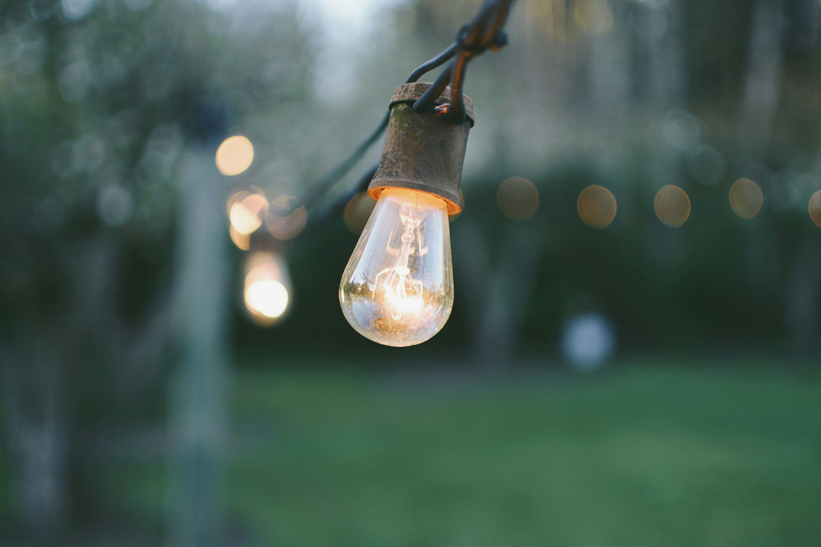 Light bulb on a wire outdoors