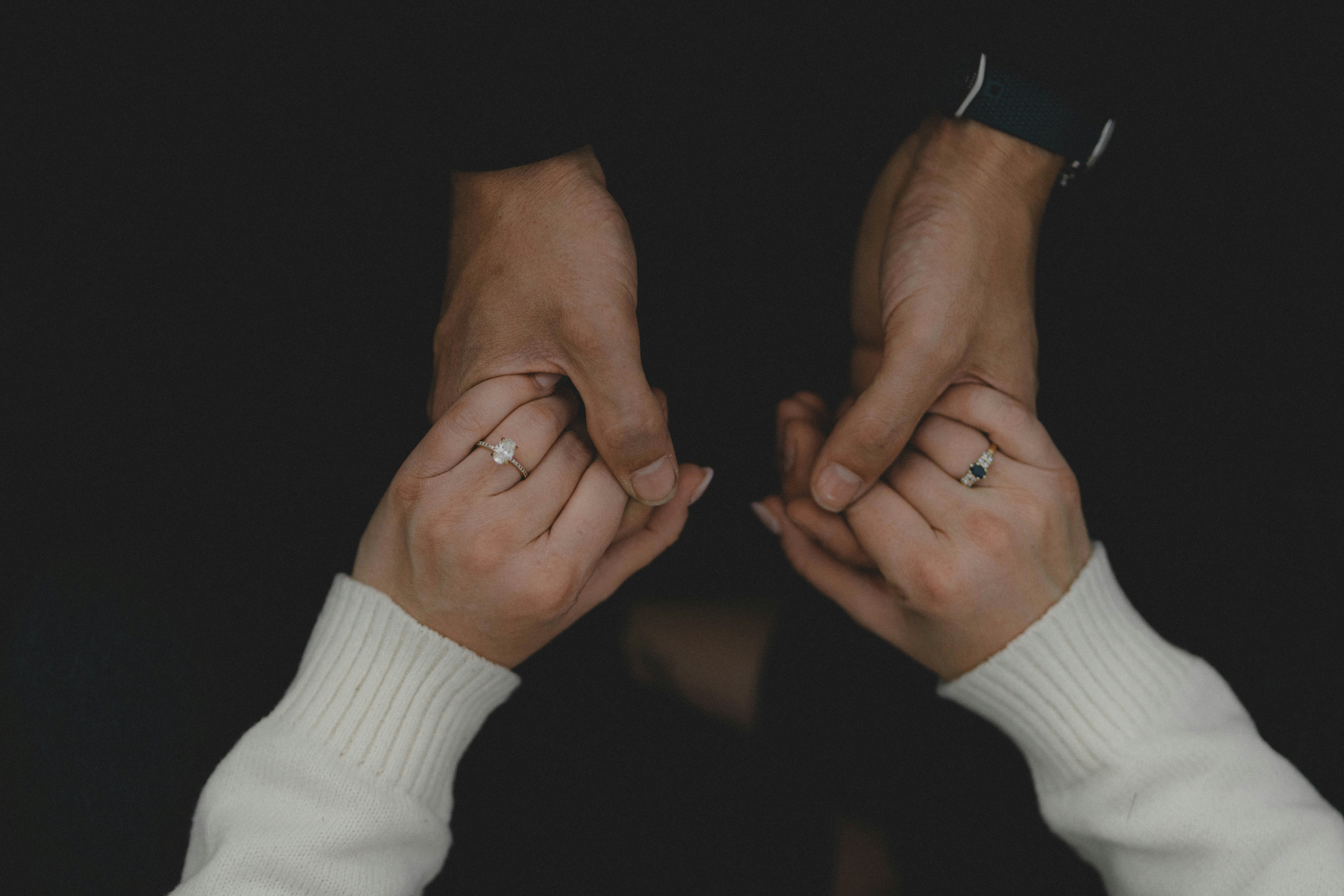 Engaged couple holding hands showing off the ring