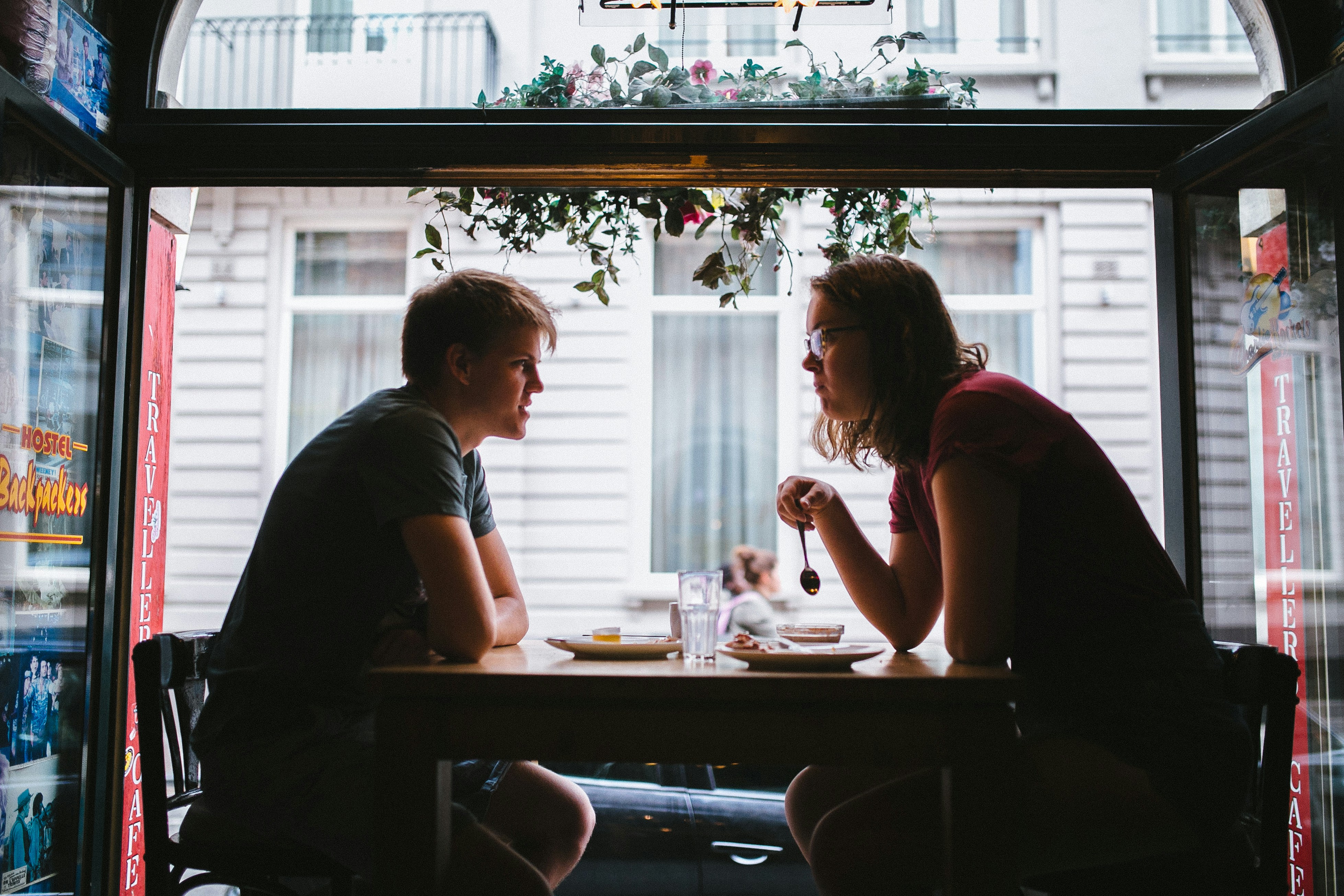 A Couple sitting in a window in the city of Brugges