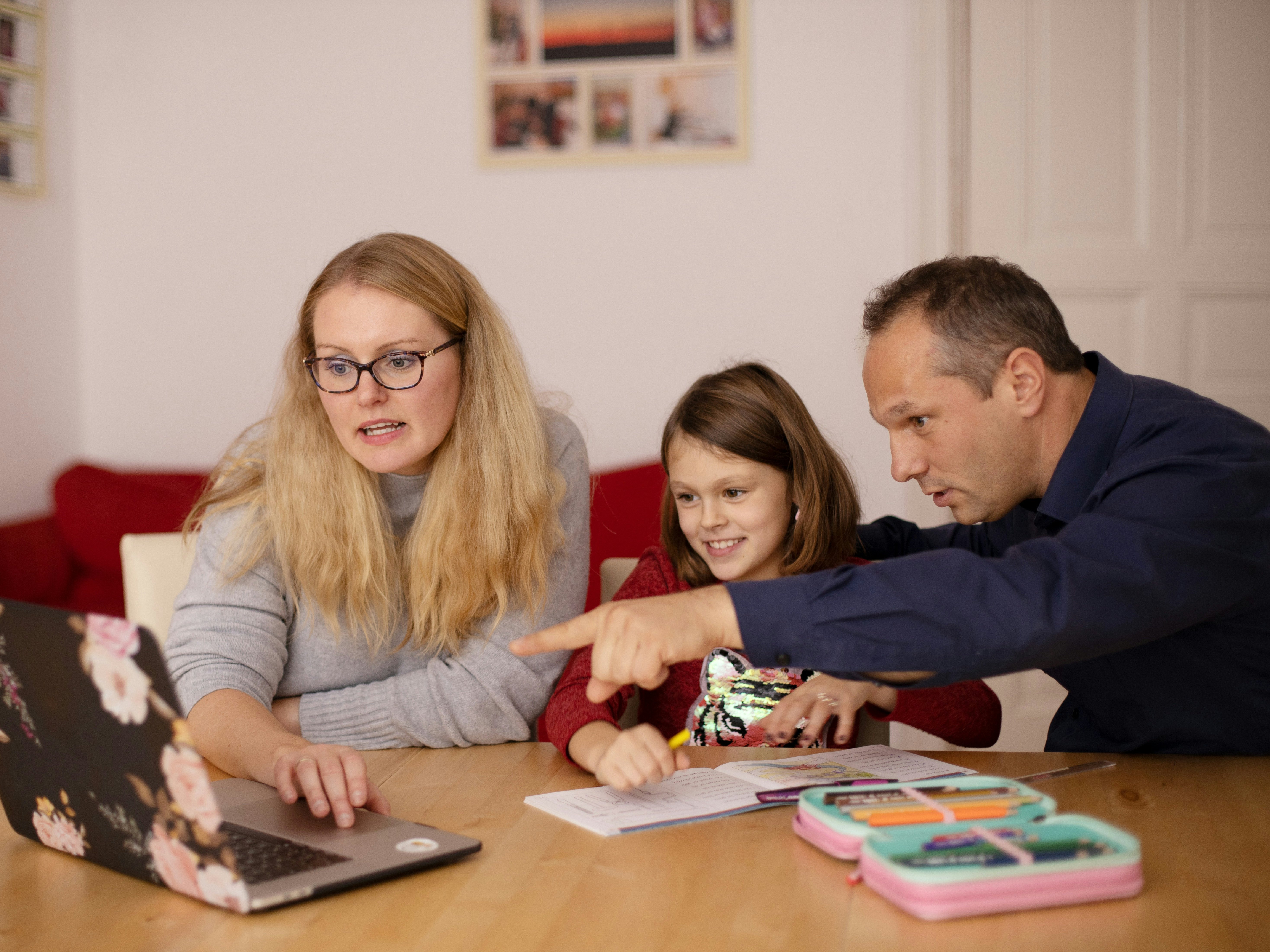 Parents learning teaching their child during homeschooling.