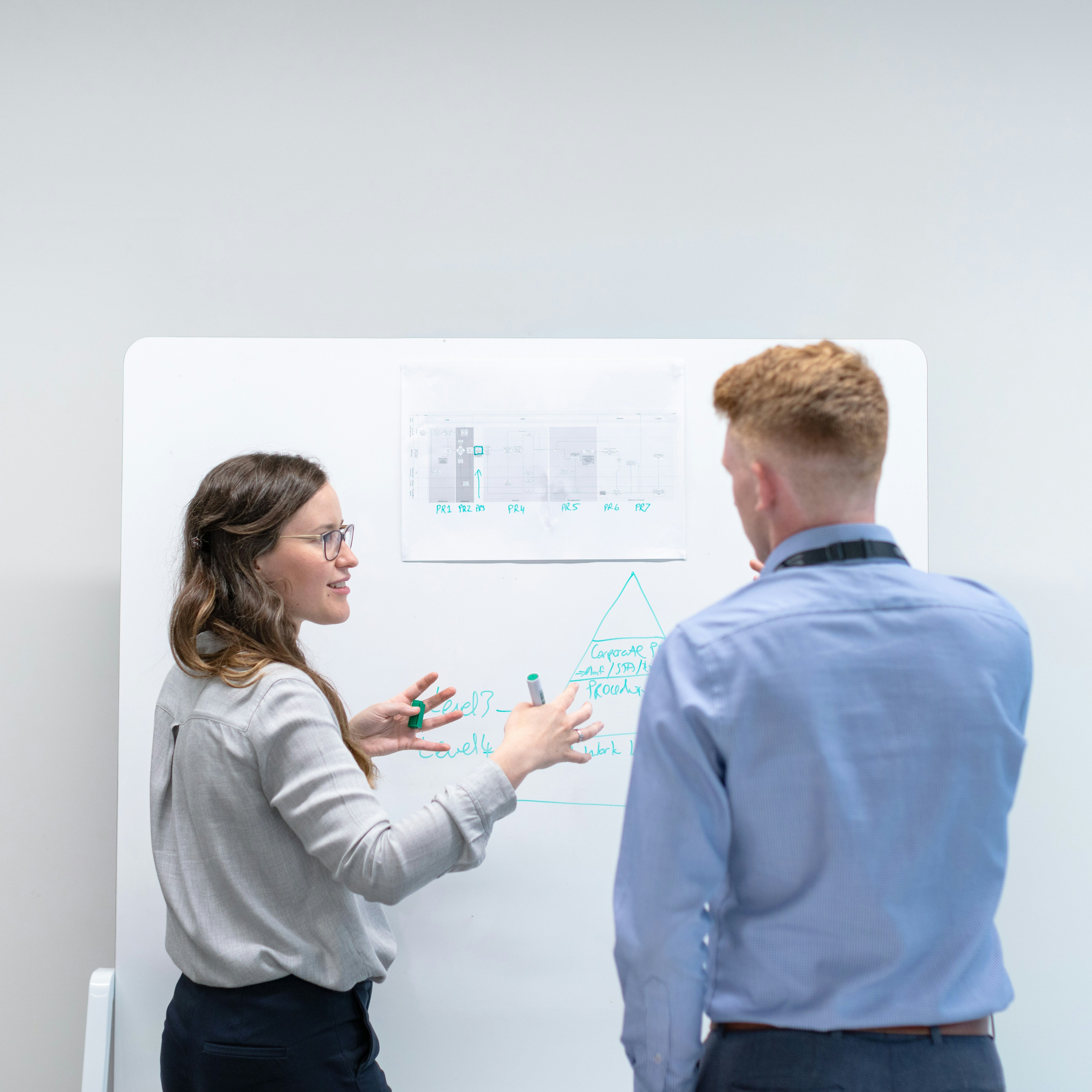 Female electronics engineer discusses data in meeting with colleague