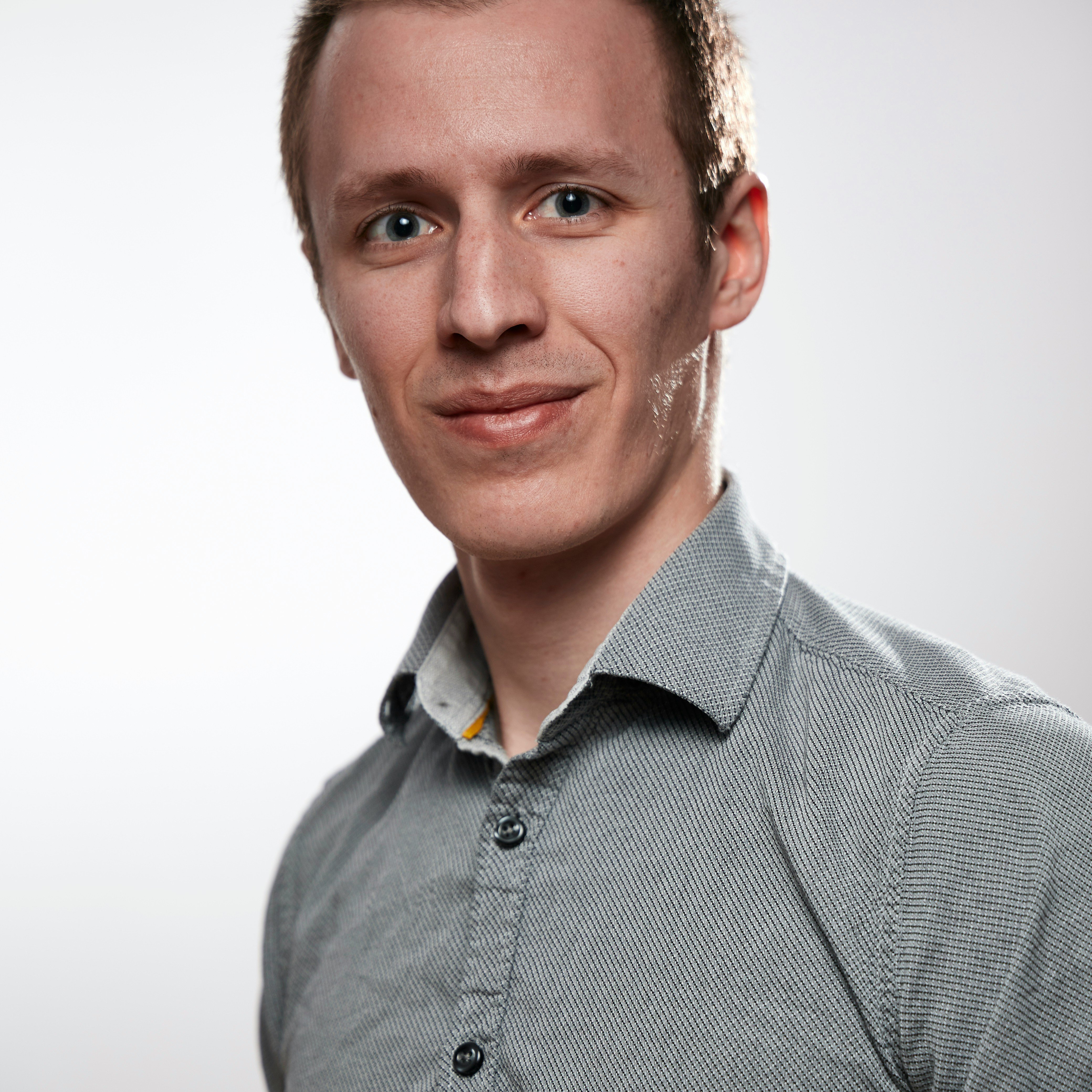 Portrait of a smiling man in clean cloths on a white background. Self portrait taken to test a brand new EOS RP.