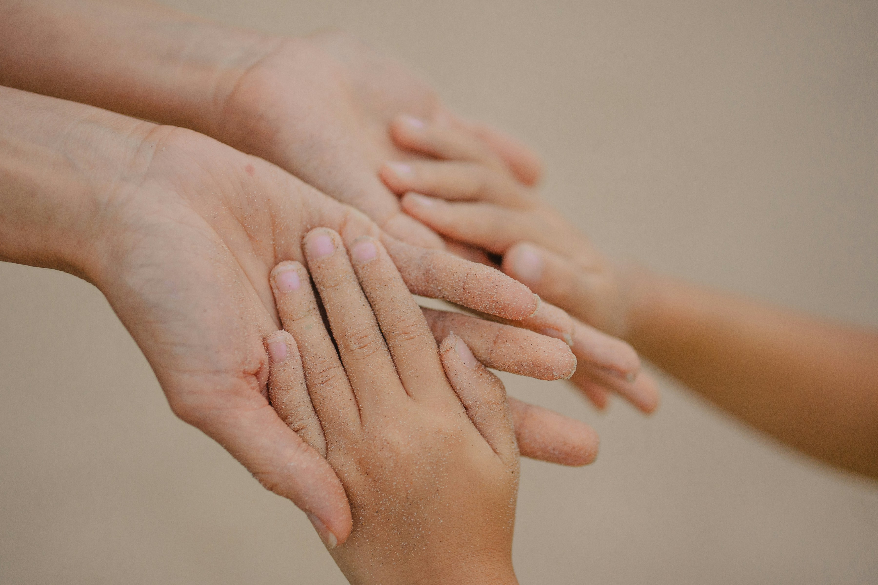 Gentle hands of a mother and child holding each other