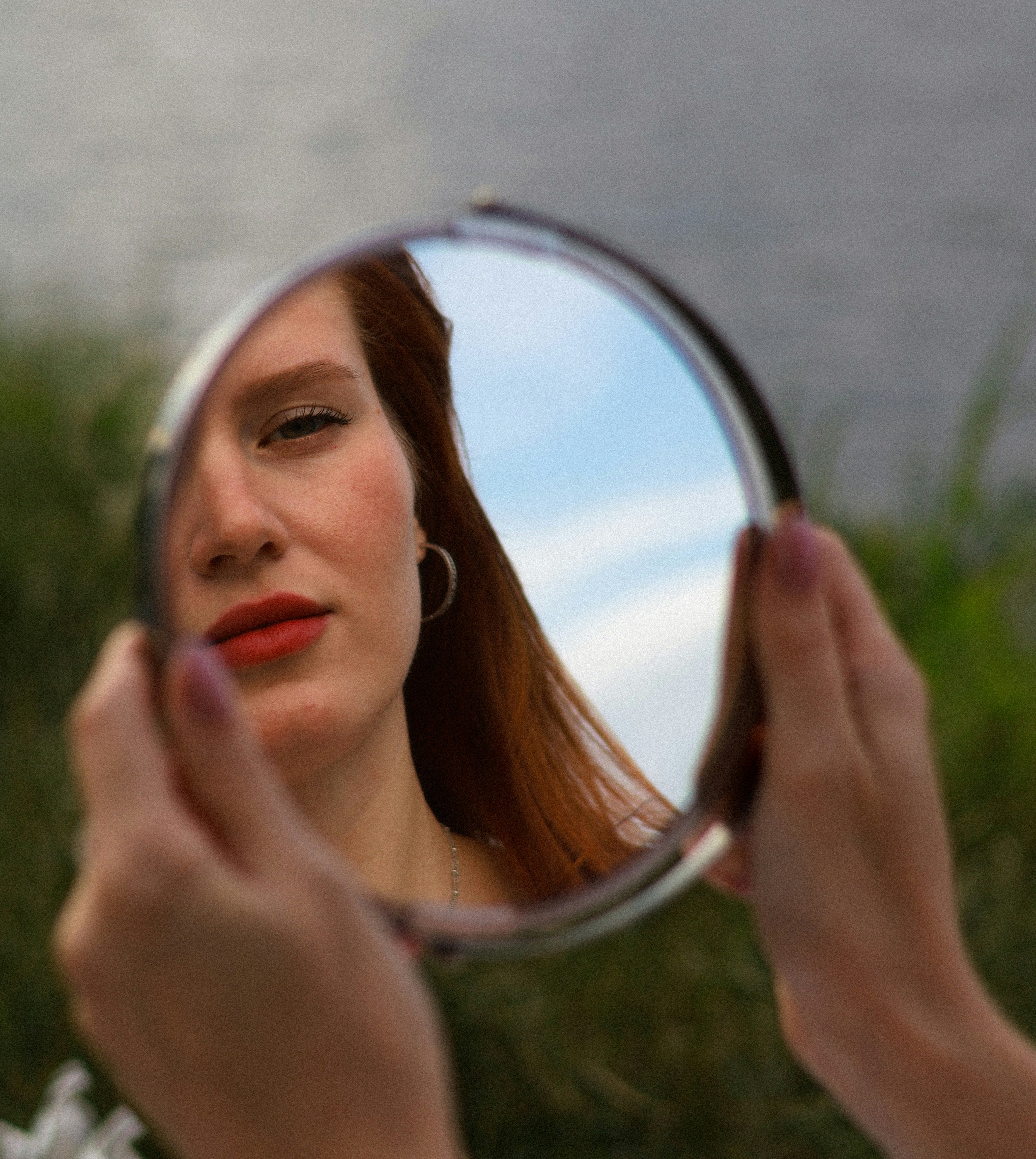red-haired woman in the mirror