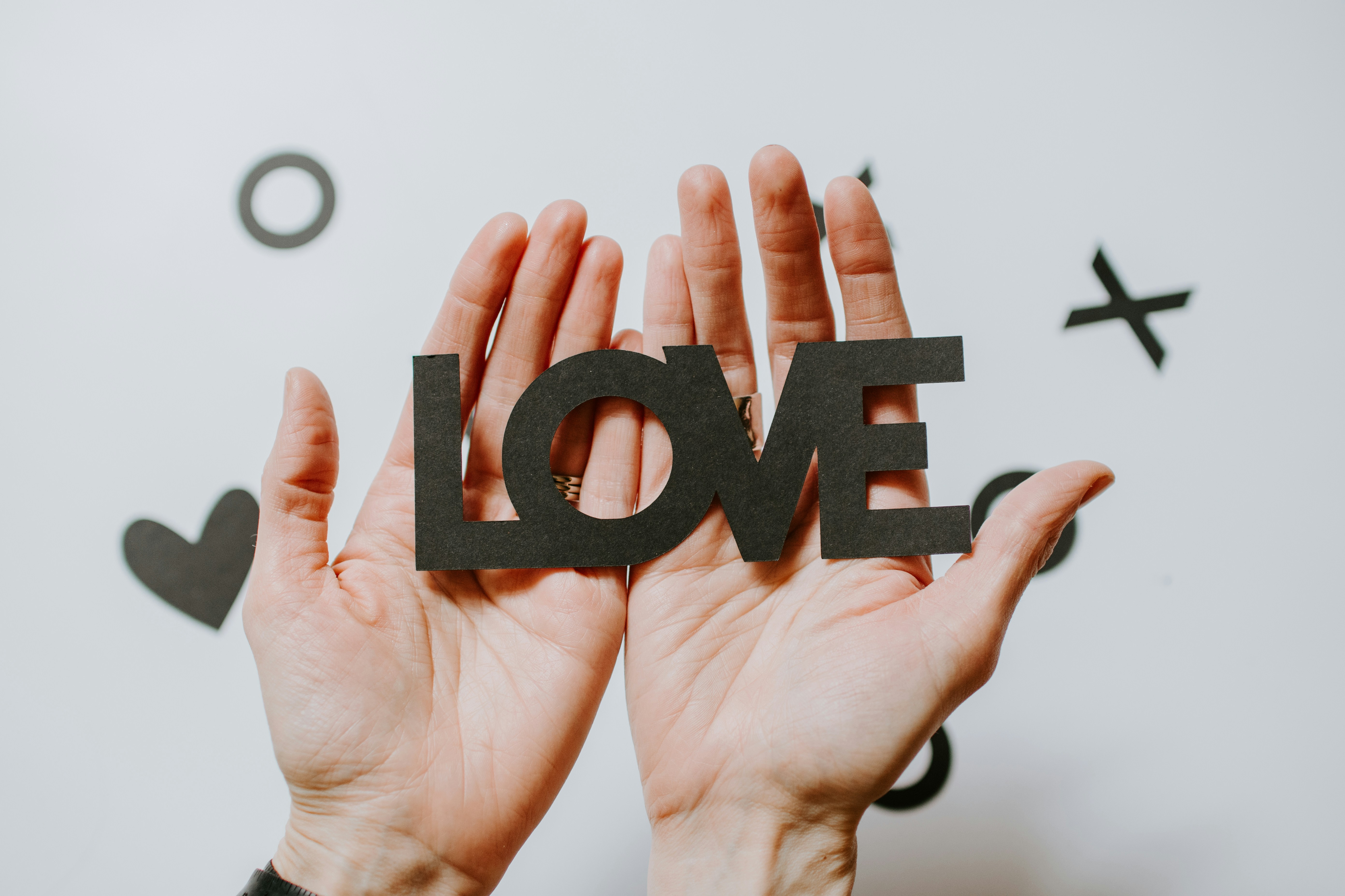 hands holding the word Love