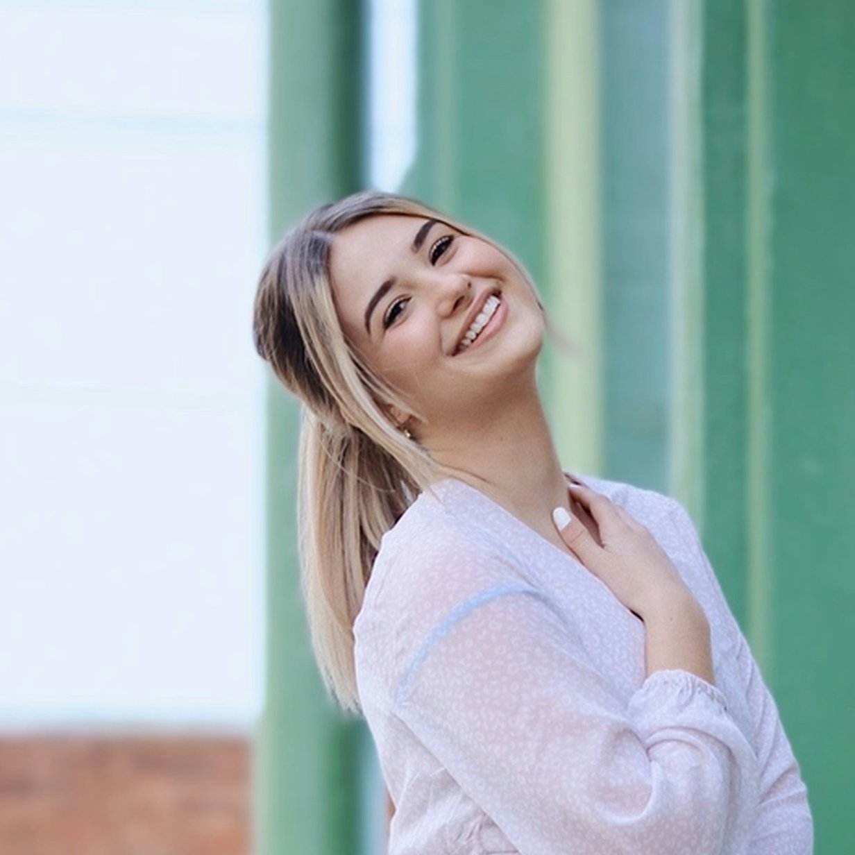 Young girl leaning back smiling
