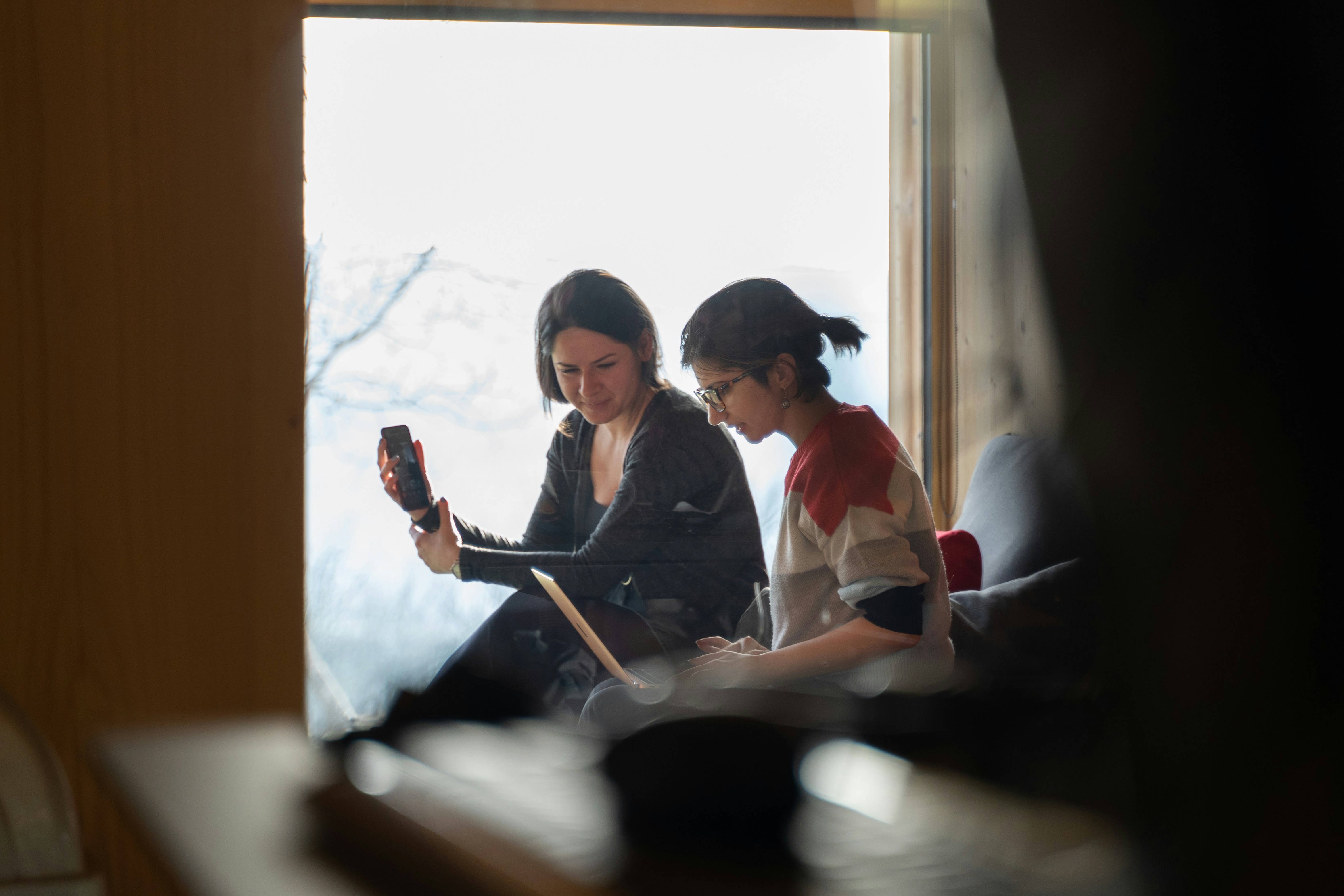 Two girls having an internal communication meeting