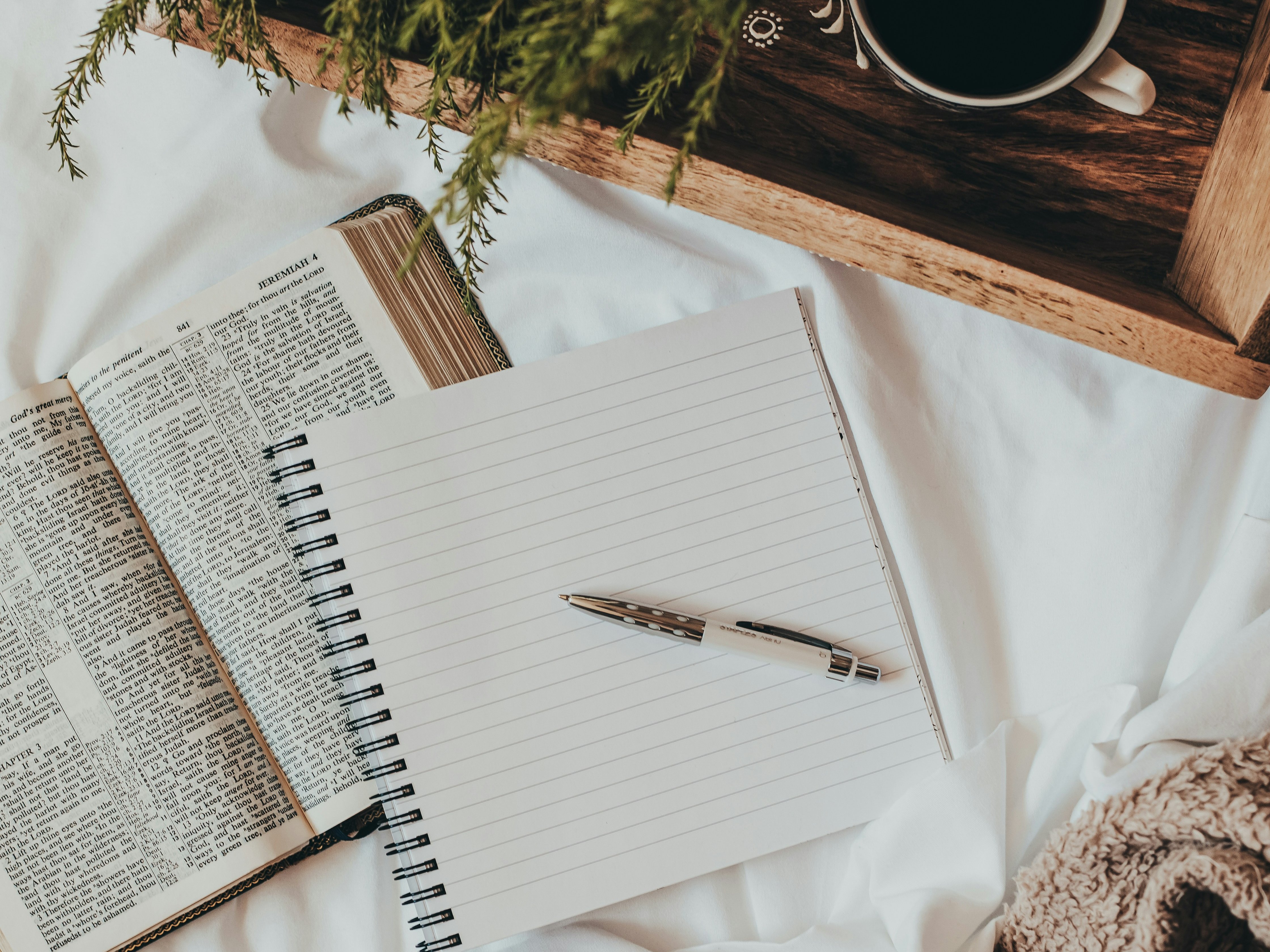 Cozy scene with God's Word, a journal and a cup of coffee.